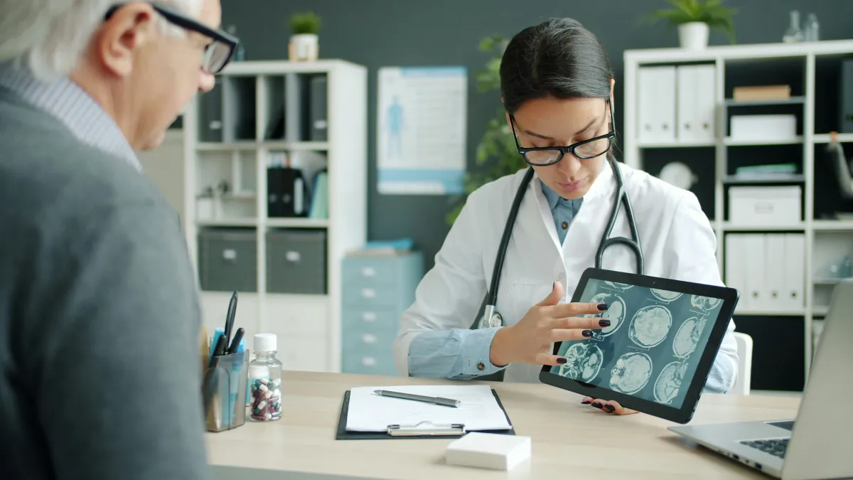 Doctor conducting video consultation on laptop